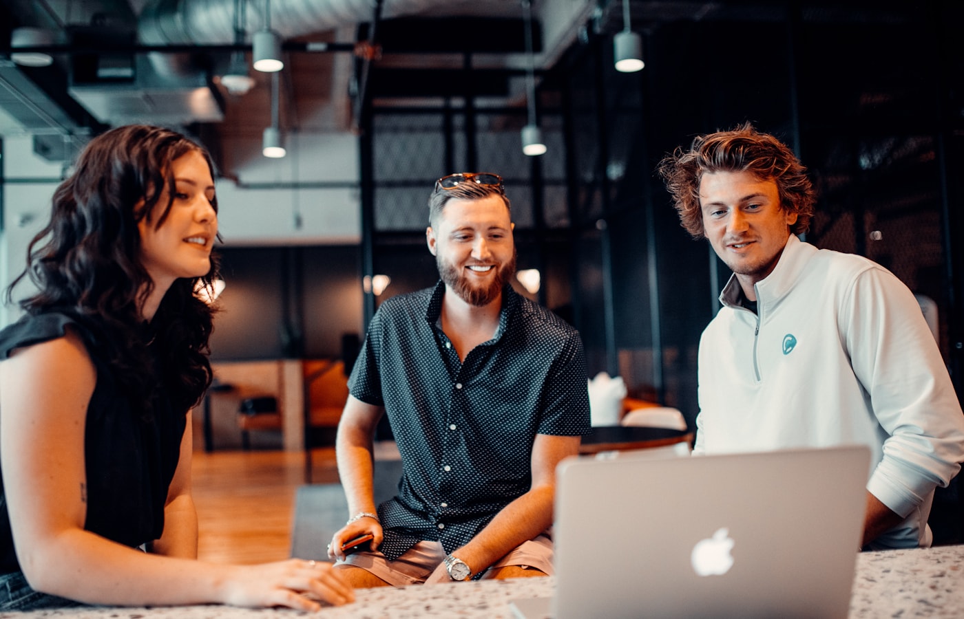 A team reviewing website analytics and navigation decisions around a laptop